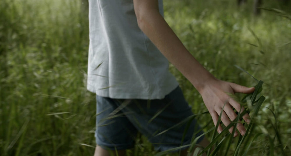 kid running hand grass