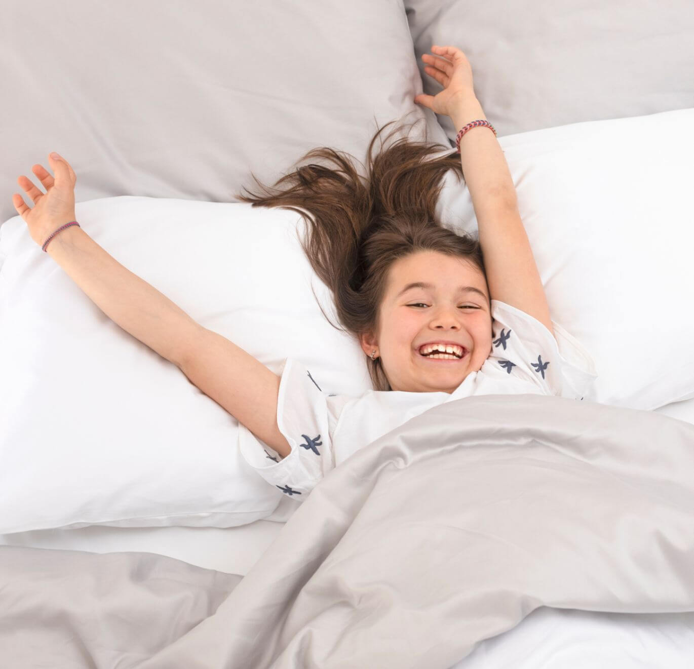 happy kid in bed with good sleep habits