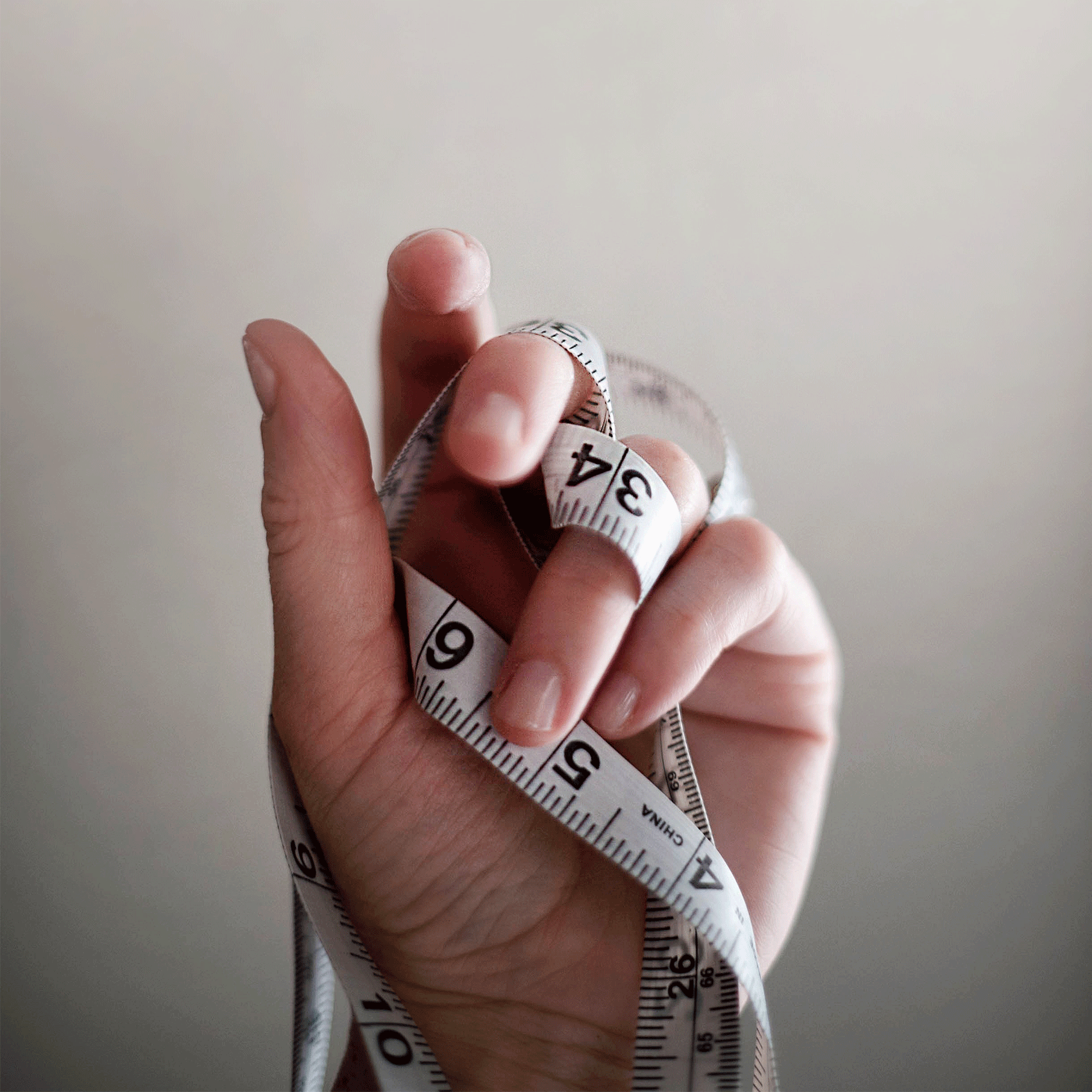 hand with measuring tape